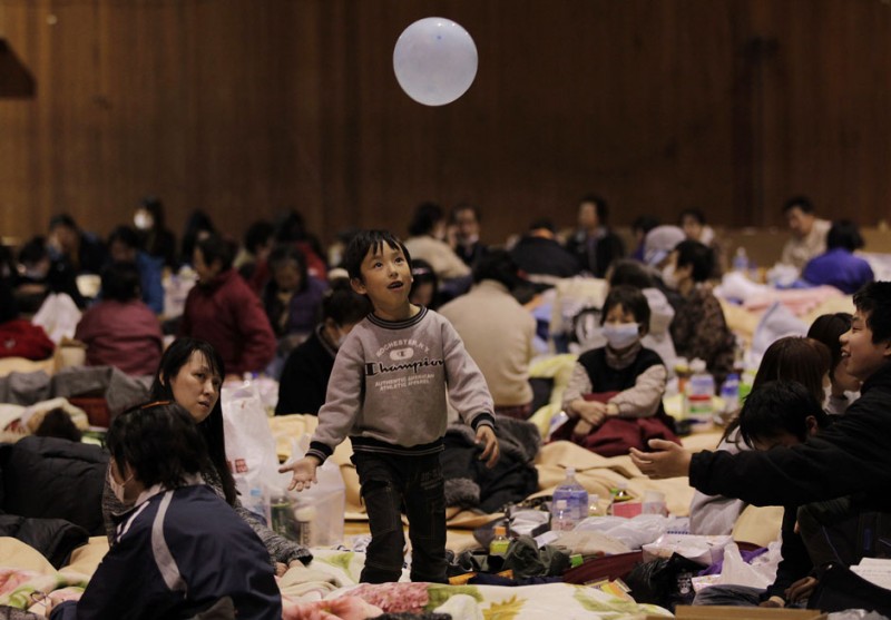 A boy plays with a balloon at an evacuation centre set in a gymnasium in Kawamata, Fukushima Prefecture in northern Japan